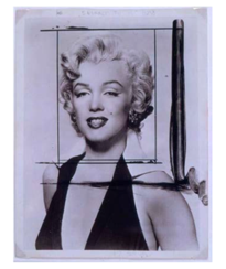 A black-and-white photograph of Marilyn Monroe wearing a dark halter dress, smiling slightly. The photo has crop marks and black paint streaks on it, suggesting it was used as source material for an art piece or printmaking.